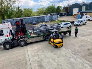 AJN steel being unloaded by a forklift before it's used in construction at the Harlow Food Bank