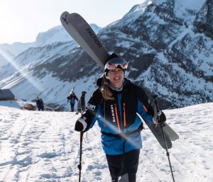 Charity mountain climber smiling whilst wearing AJN branded climbing gear
