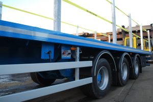 The side of one of AJN rigid trailer with control buttons in focus
