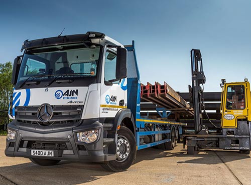 An AJN lorry being loaded by a CombiLift, lifting processed steel onto the trailer