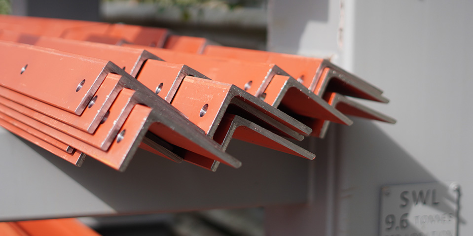 Saw cut, shot blasted and drilled Angles A group of steel angles that have been cnc drilled, cnc saw cut, shot-blasted and painted to customer specifications, sitting in AJN Steelstock's Kentford yard awaiting delivery
