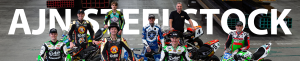 A group of superbike and speedway riders looking up at a camera, similing for a photosoot with the text AJN Steelstock behind them